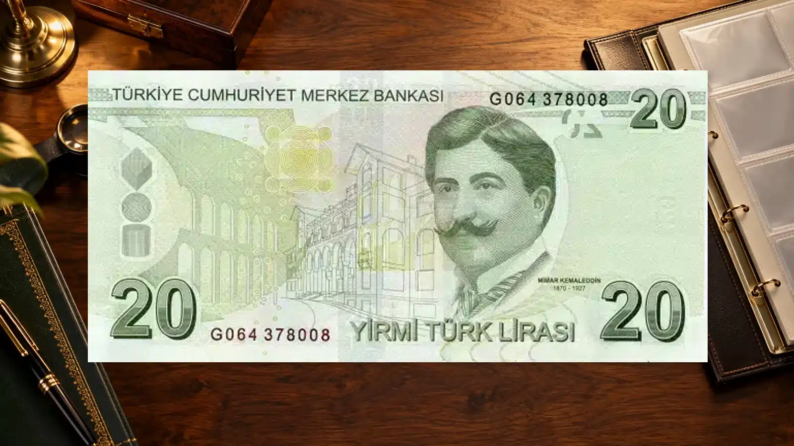 Original reverse of a Turkish 20-lira banknote with Mimar Kemaleddin, displayed beside an album and magnifier on a walnut collector desk